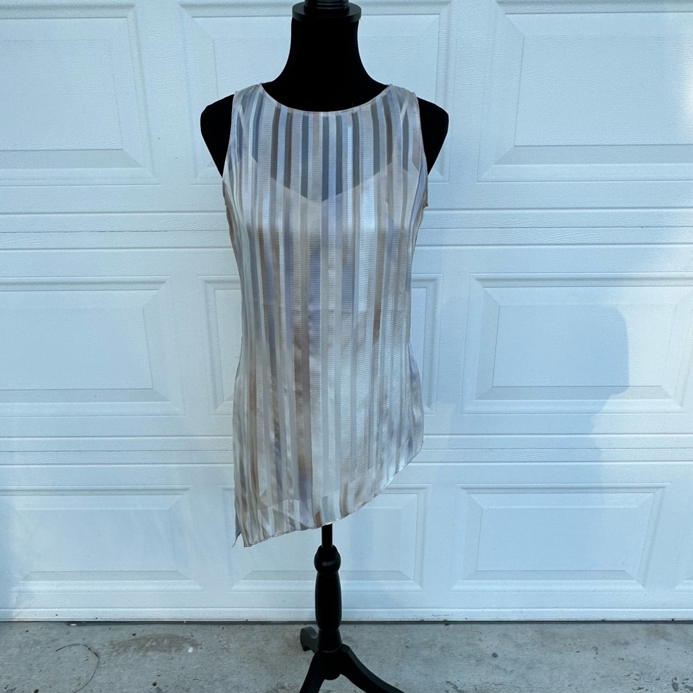 Beautiful asymmetrical sleeveless top. The perfect neutral layering piece